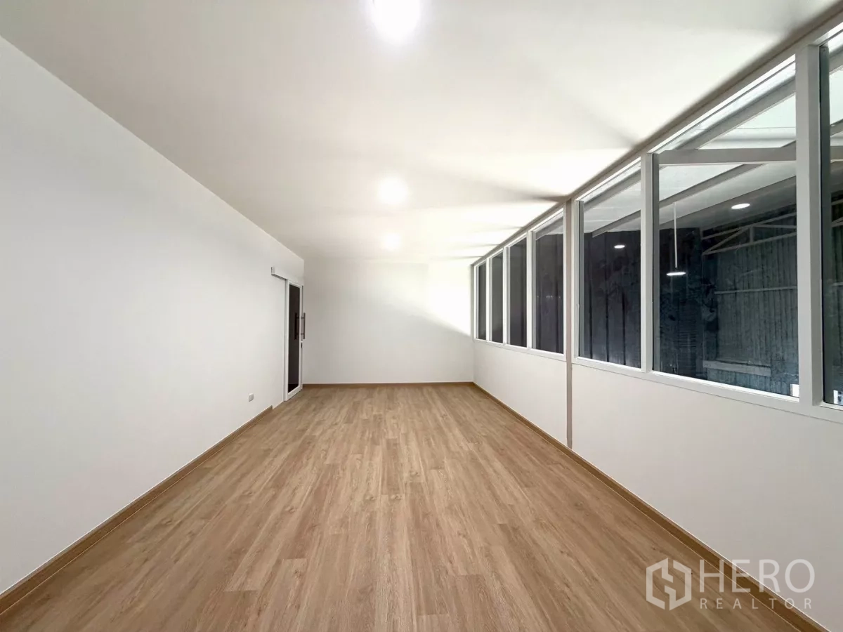 Warehouse for rent in Suan Luang, Bangkok - Bright mezzanine office with wood-look flooring and long internal windows overlooking the warehouse floor.
