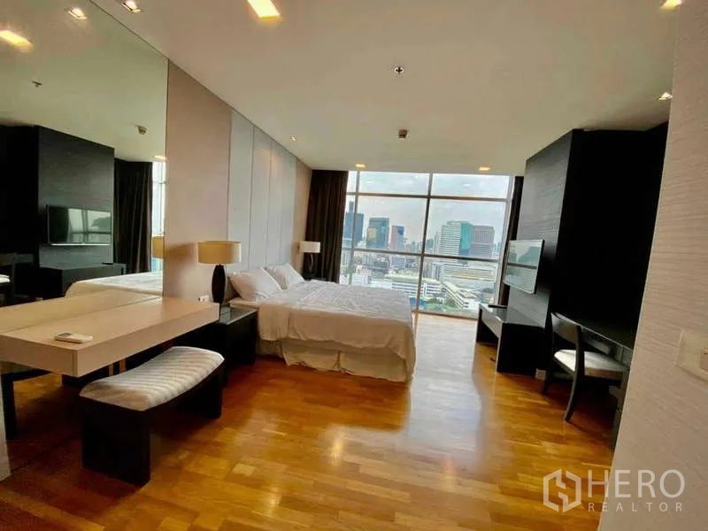 Condominium for rent or sale in Sathon, Bangkok - Wide bedroom view with city panorama through floor-to-ceiling glass.