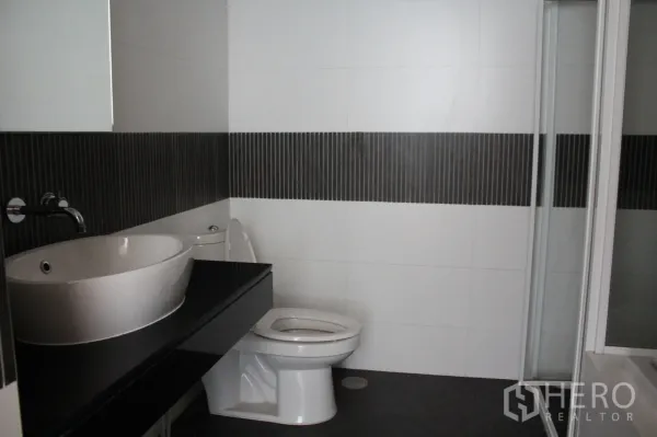 คอนโด ให้เช่าในSathon, Bangkok - ห้องน้ำสไตล์โมเดิร์น อ่างล้างหน้าแบบถ้วย เคาน์เตอร์สีดำ โถสุขภัณฑ์ และห้องอาบน้ำกระจก