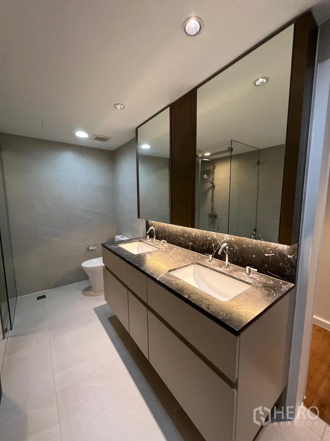 Condominium for rent or sale in Sathon, Bangkok - Contemporary bathroom with marble double vanity and large mirrors.