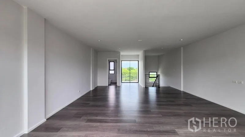Home Office for rent - Open workspace floor with rear balcony access and side stair.