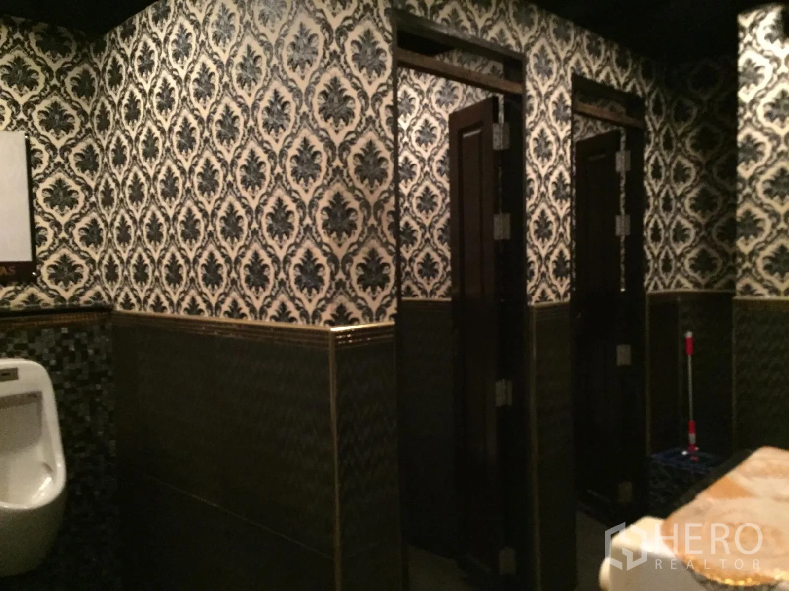 Retail Space for rent in Watthana, Bangkok - Restroom with ornate wallpaper, tiled wainscoting and multiple stall doors.