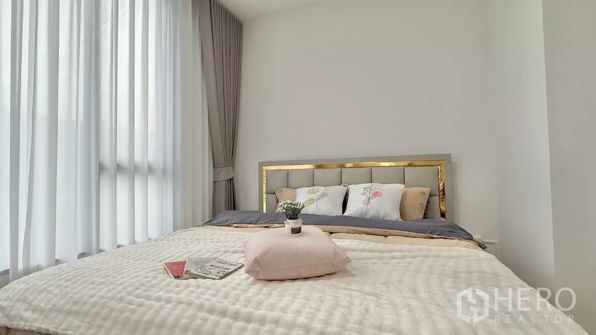 Townhouse for rent in Bang Phli, Samut Prakan - Master bedroom with large windows, sheer curtains and upholstered bed.