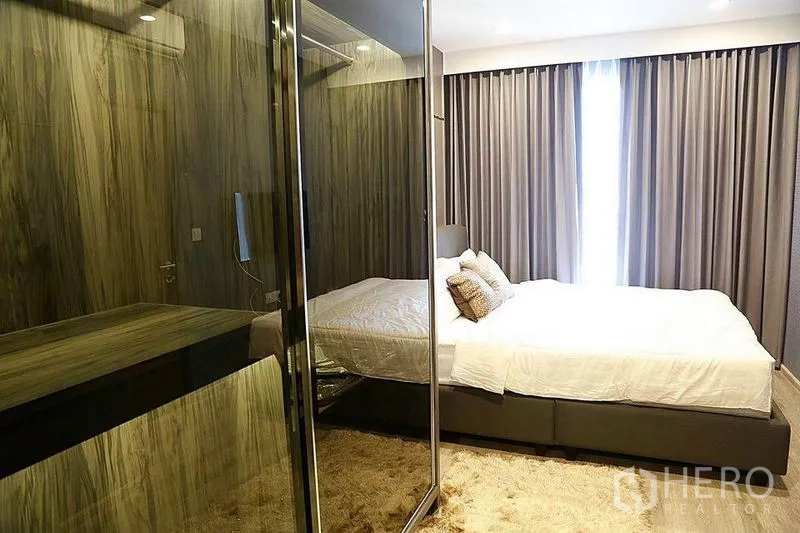 公寓 出租在Huai Khwang, Bangkok - 卧室配玻璃衣柜、纹理墙面和落地窗帘。