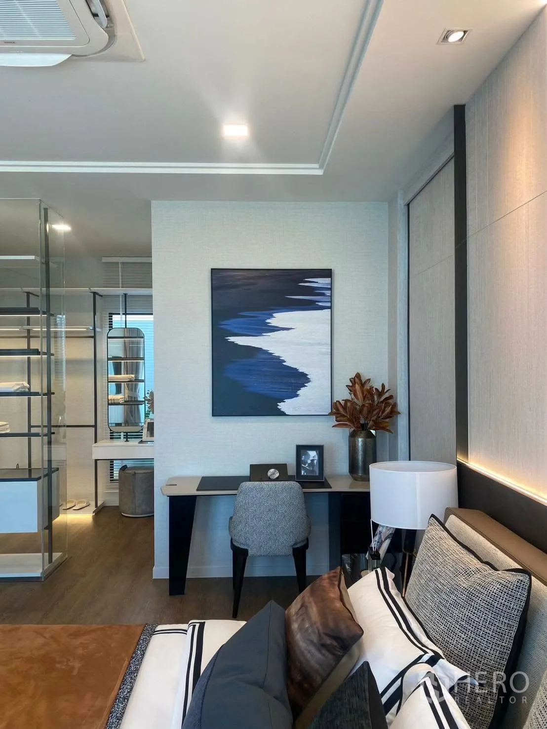 Detached House for rent or sale in Bang Phli, Samut Prakan - Stylish bedroom with a study desk, modern artwork, and a glass wardrobe area.
