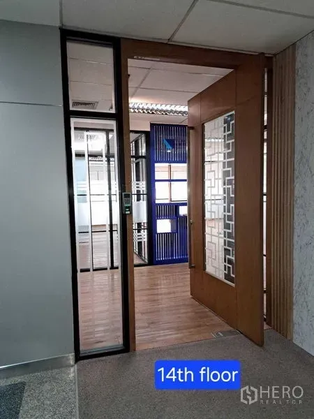 Office Space for rent in Bang Rak, Bangkok - Entrance to 14th‑floor office with wooden and glass door revealing partitioned workspace.