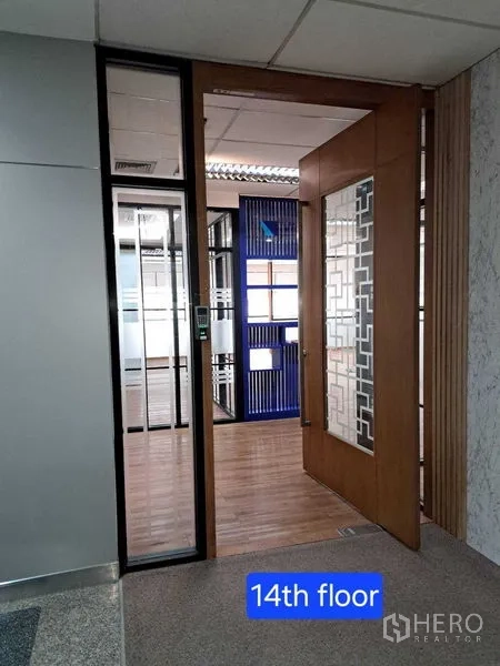 Office Space for rent in Bang Rak, Bangkok - Entrance to 14th‑floor office with wooden and glass door revealing partitioned workspace.