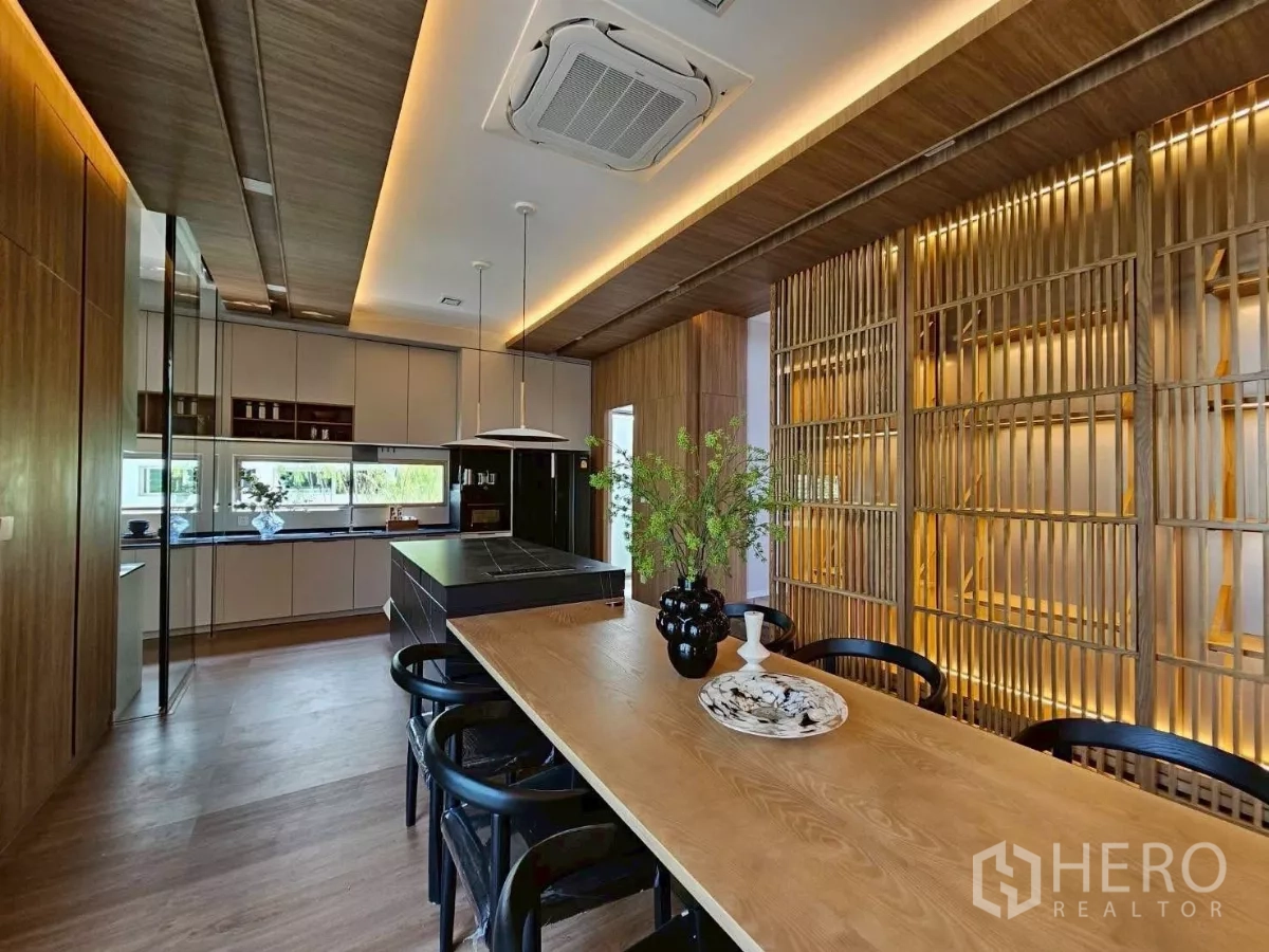Detached House for rent in Saphan Sung, Bangkok - Modern kitchen with island cooktop, pendant lights, and built-in cabinets.