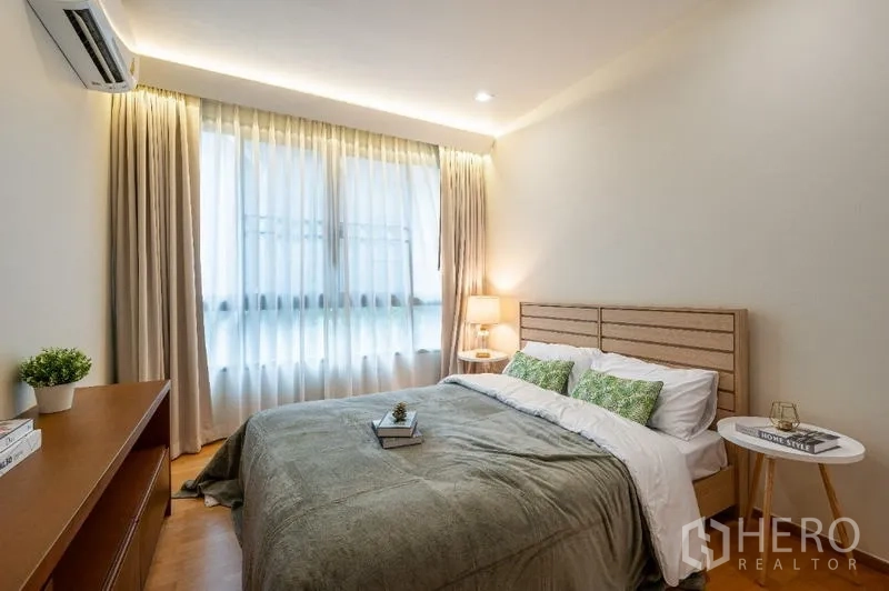 Condominium for sale - Cozy bedroom with double bed, soft lighting and large curtained window.