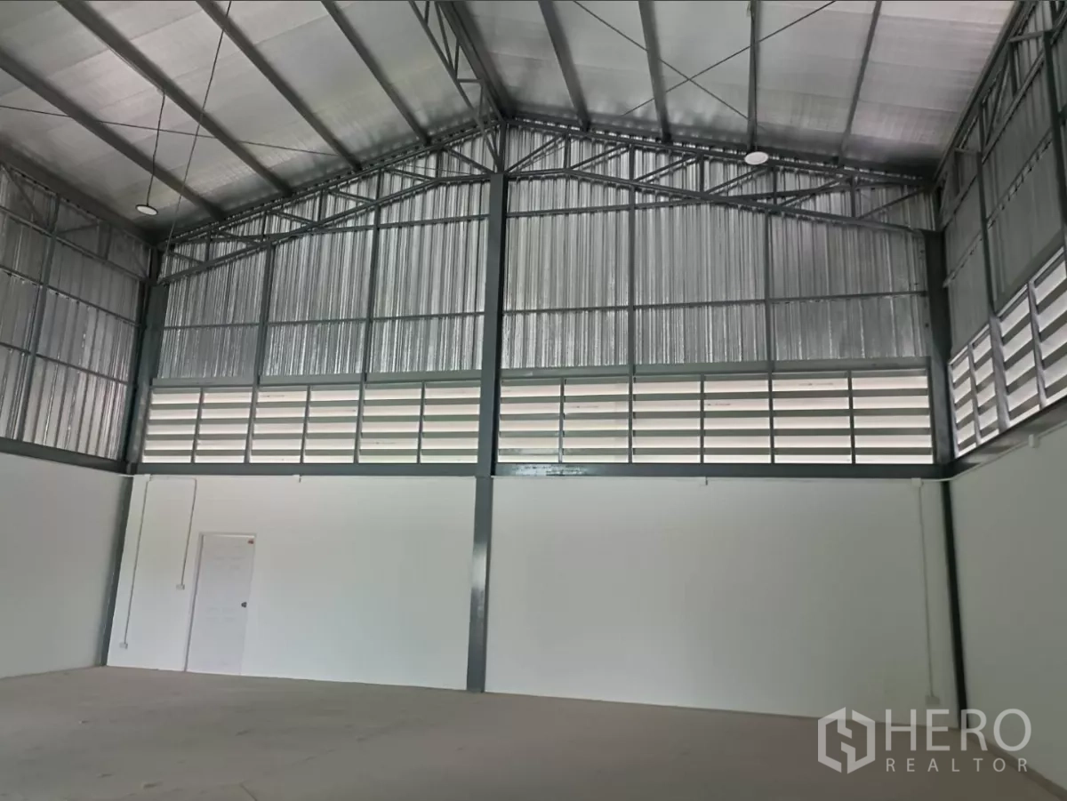 Factory for rent or sale in Bang Yai, Nonthaburi - Warehouse gable wall showing ventilated louver panels and metal cladding.