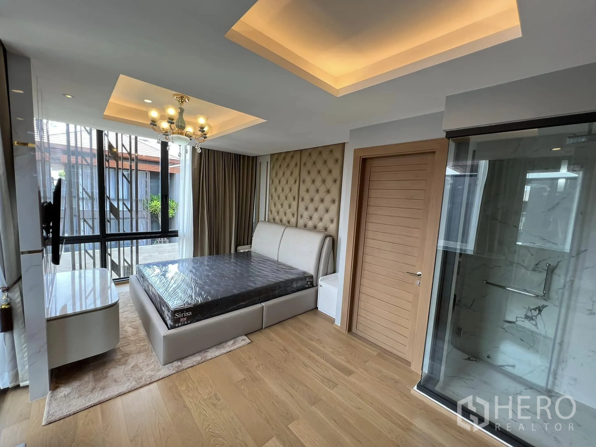 Detached House for rent or sale in Yan Nawa, Bangkok - Bedroom with glass-enclosed shower and upholstered headboard.