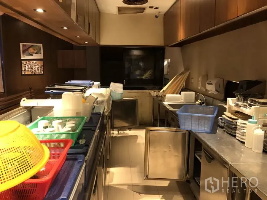 Retail Space for rent in Khlong Toei, Bangkok - Commercial kitchen with stainless counters, under-counter fridges and overhead cabinets in warm lighting.