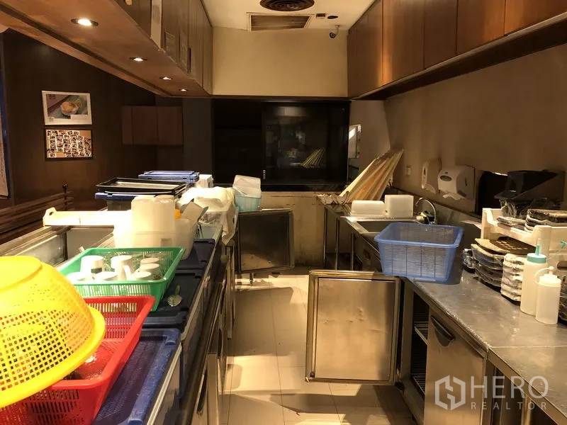 Retail Space for rent in Khlong Toei, Bangkok - Commercial kitchen with stainless counters, under-counter fridges and overhead cabinets in warm lighting.