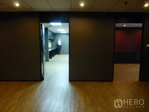 Office Space for rent in Watthana, Bangkok - Central hall leading to a bright pantry and meeting room, with timber floors and grid ceiling lights.
