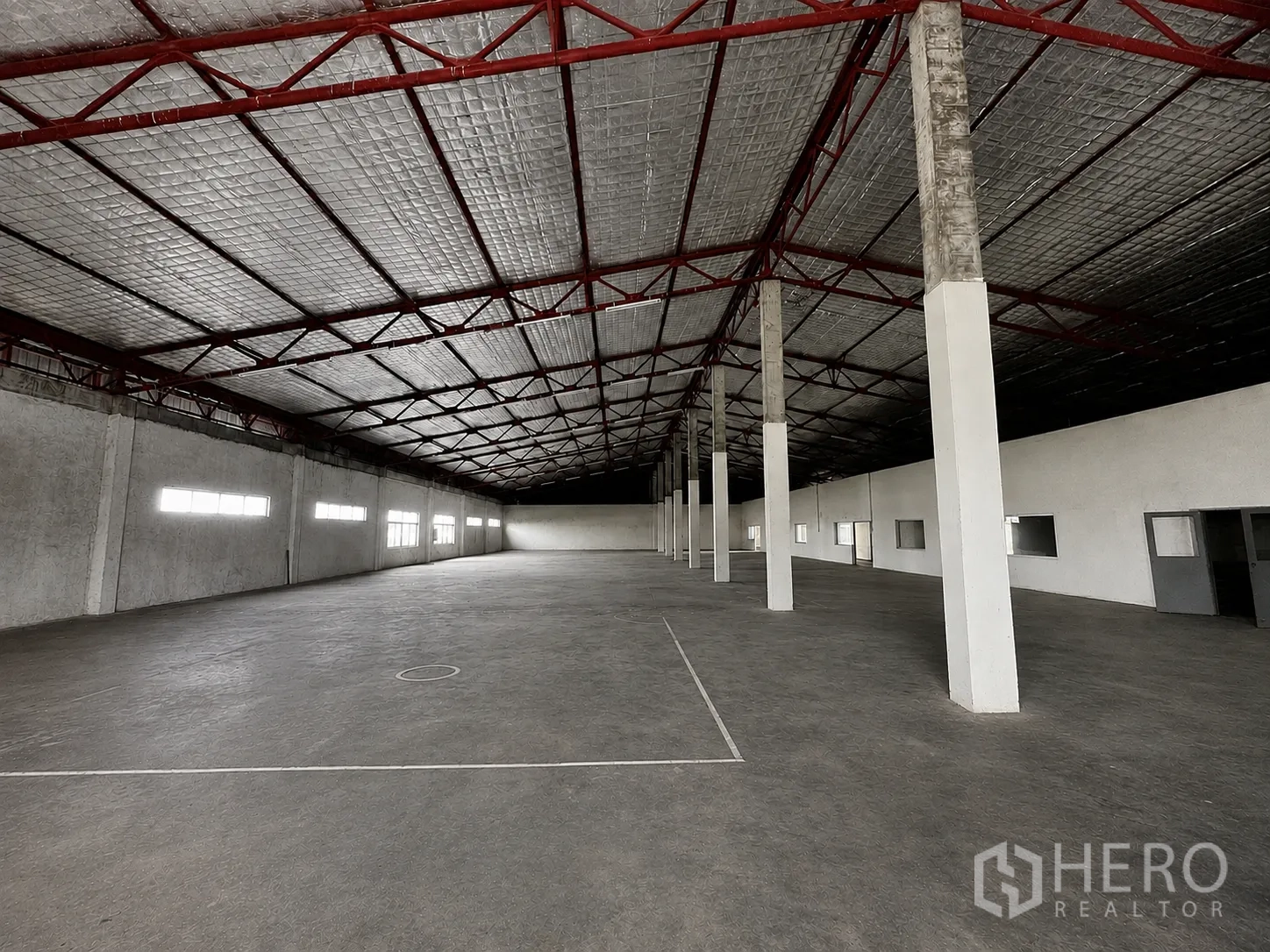 Factory for rent or sale in Wang Noi, Phra Nakhon Si Ayutthaya - Warehouse-style hall with insulated foil roof, red steel trusses, and long clerestory windows.