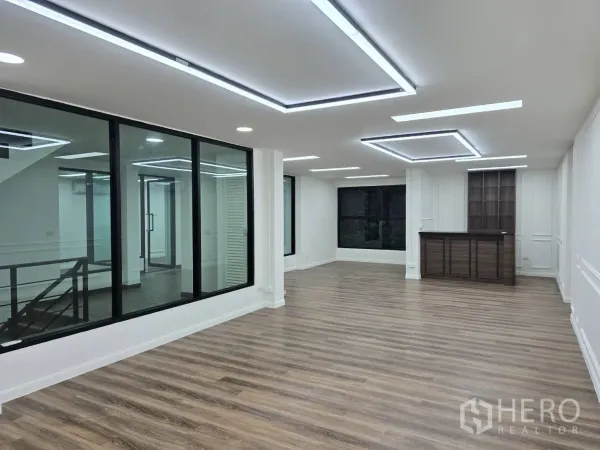Home Office for rent in Chatuchak, Bangkok - Spacious open-plan office with LED lighting, large windows and built-in wood cabinetry.