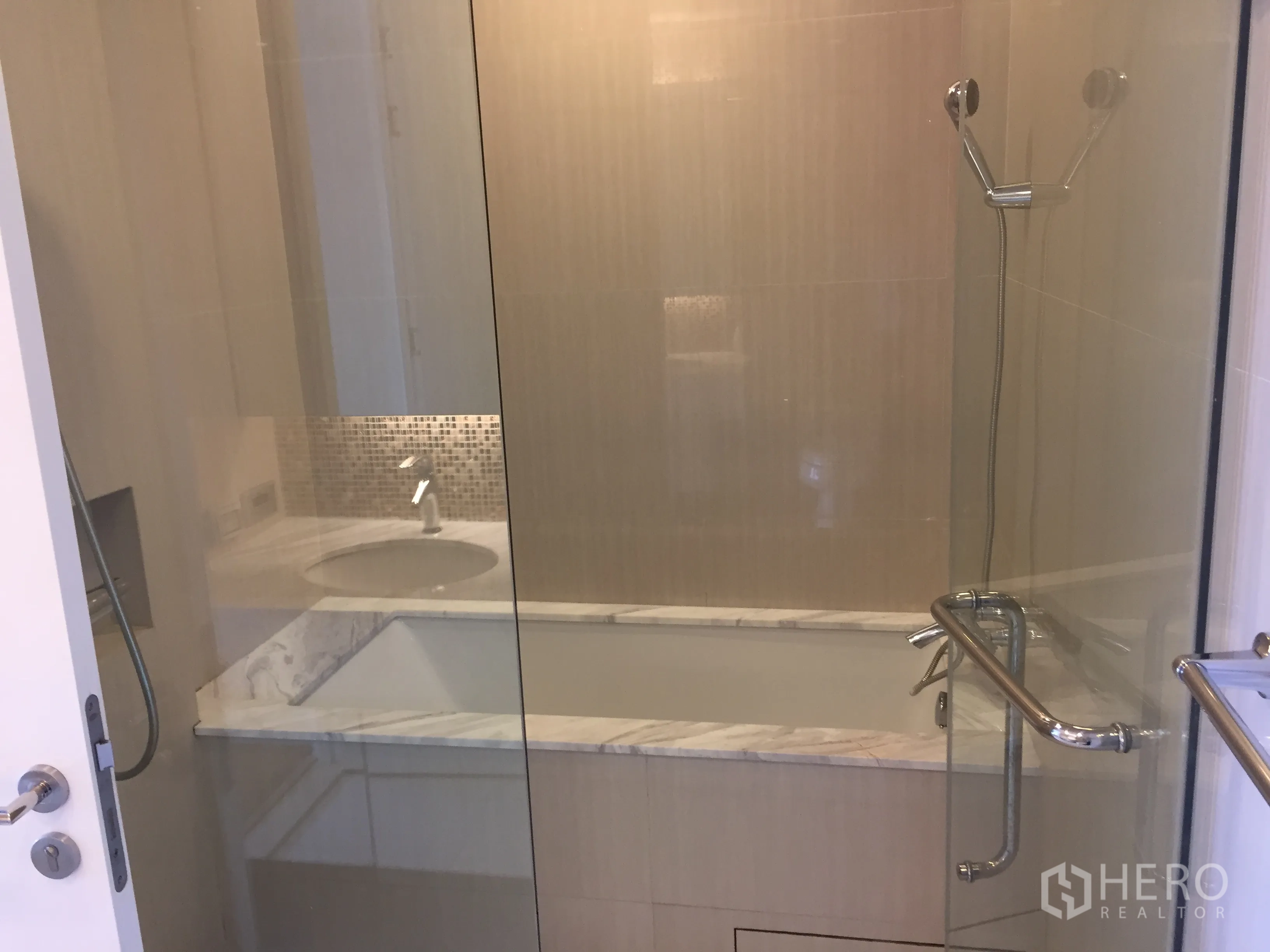 Condominium for rent in Ratchathewi, Bangkok - Bathroom with glass enclosure, bathtub, rain shower, and marble countertop.