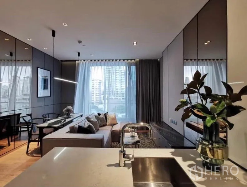 Condominium for rent in Khlong Toei, Bangkok - View from kitchen sink toward lounge and balcony-style window with skyline