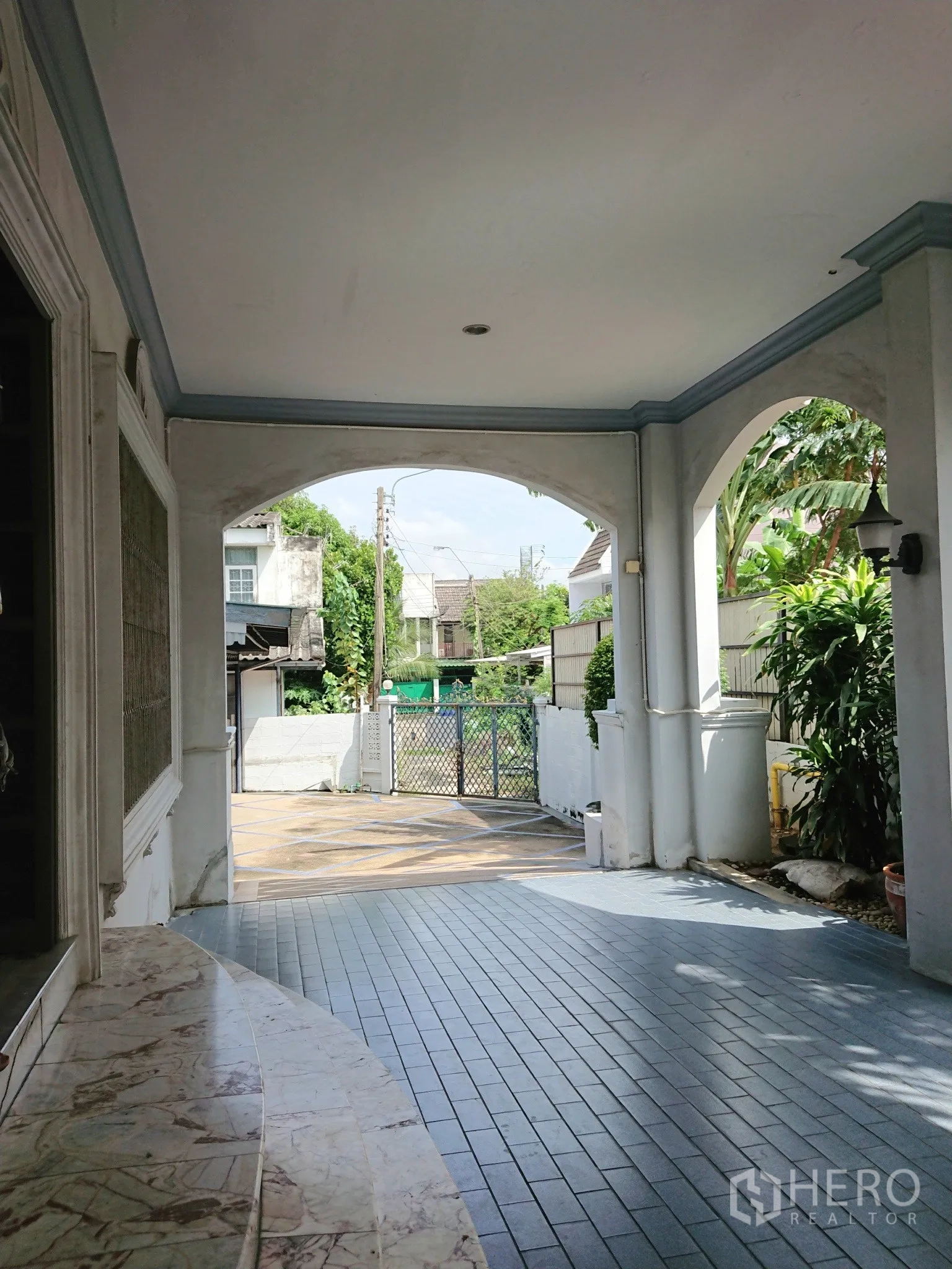 Detached House for sale in Chatuchak, Bangkok - Covered carport and side porch connecting to garden and front gate.