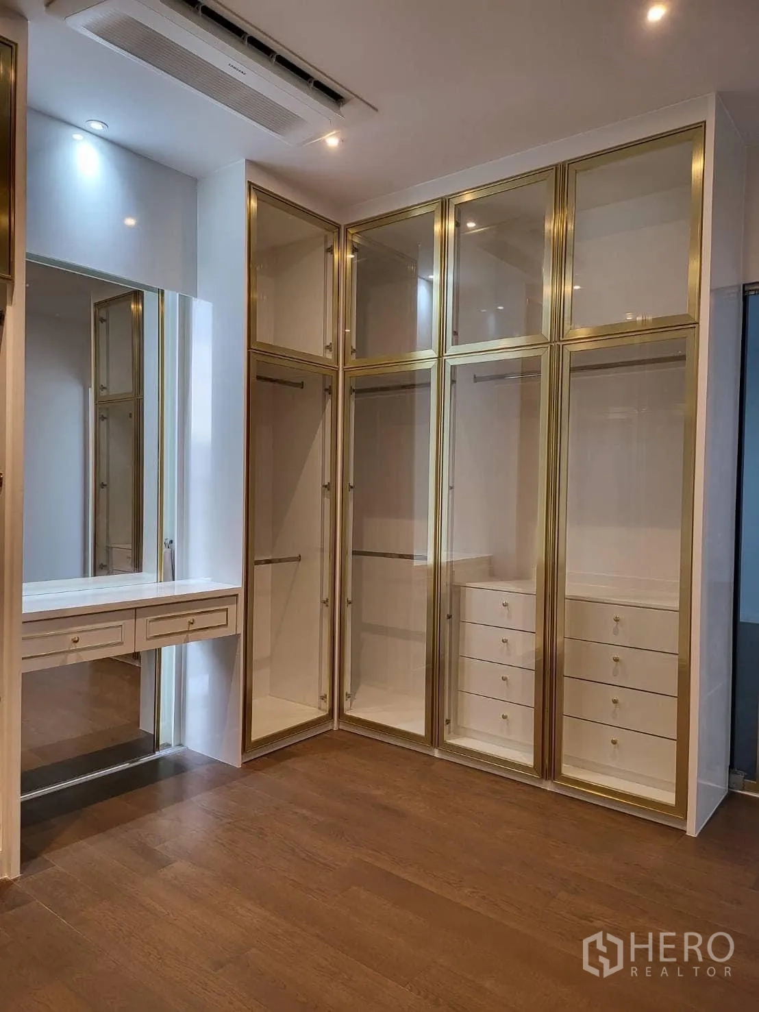 Detached House for rent - Another view of the walk-in wardrobe showing full-height storage and a makeup vanity.