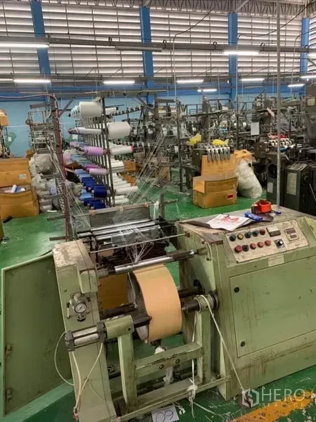 Warehouse for sale in Mueang Samut Sakhon, Samut Sakhon - Control panel and spooling equipment used for fabric production in the factory zone.