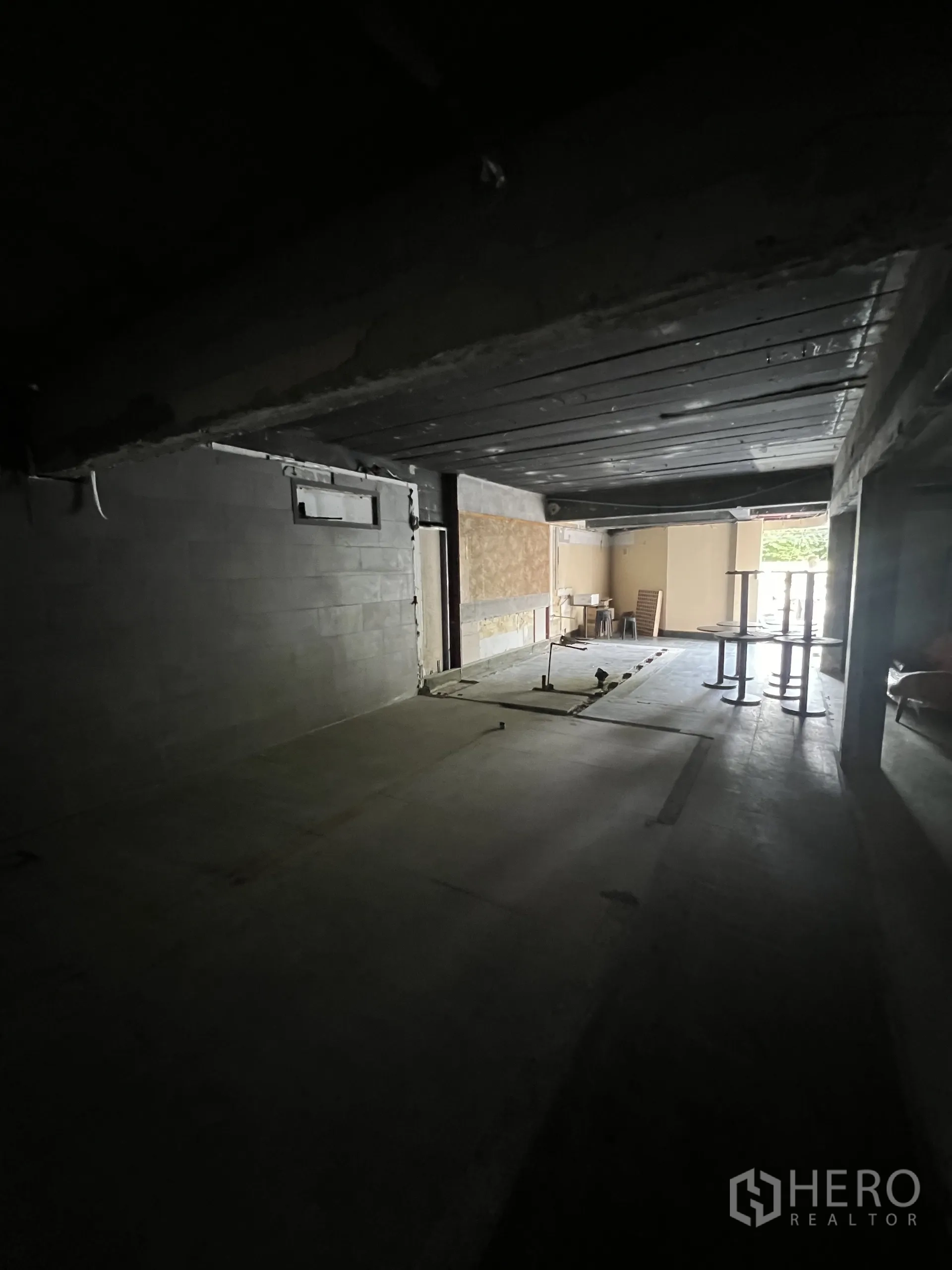 Retail Space for rent in Watthana, Bangkok - Deep shop interior with exposed beams and daylight from the front opening, ready for fit-out.