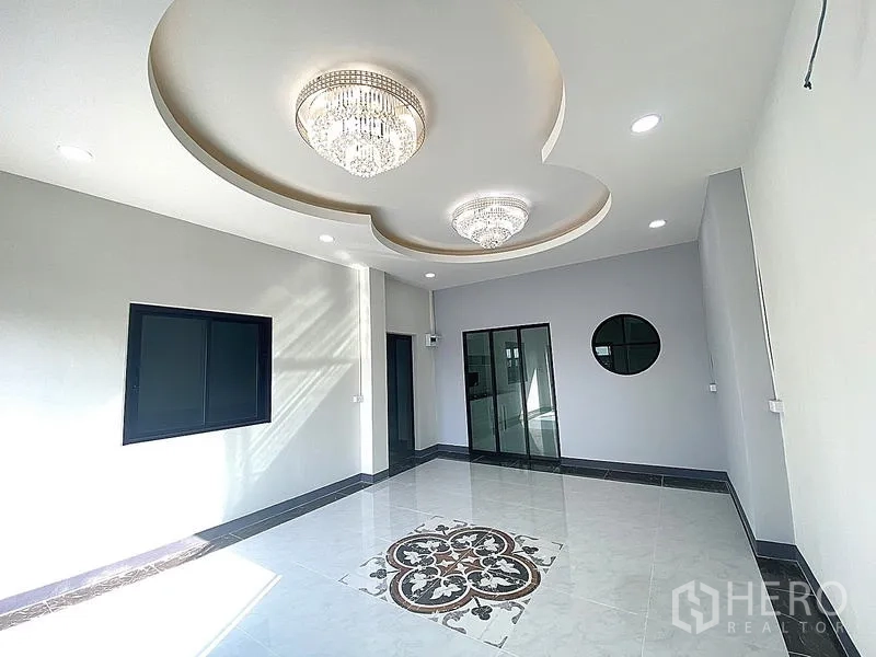 Warehouse for rent in Mueang Pathum Thani, Pathum Thani - Office lounge featuring decorative recessed ceiling, chandeliers and patterned floor tiles.