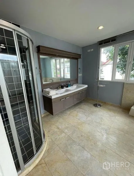 Detached House for rent - Airy bathroom featuring a curved glass shower, double-sink vanity, and a big window.