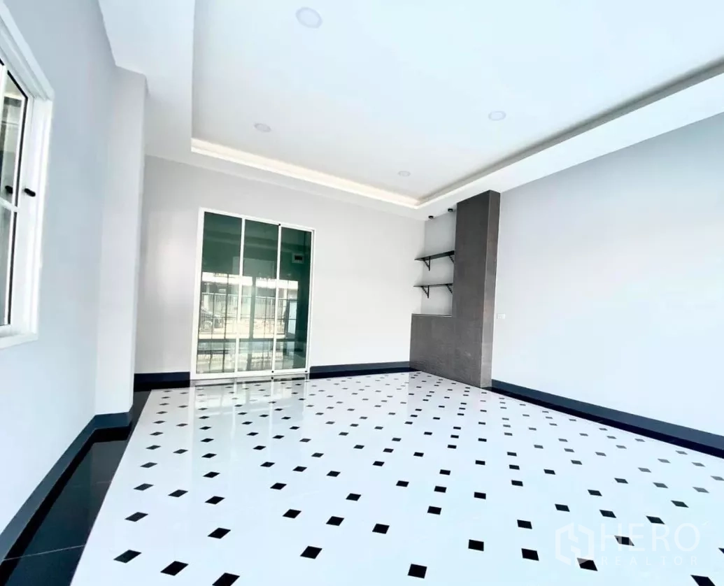 Factory for rent or sale in Bang Bua Thong, Nonthaburi - Airy office or living room with glossy patterned tile floor and glass partition.