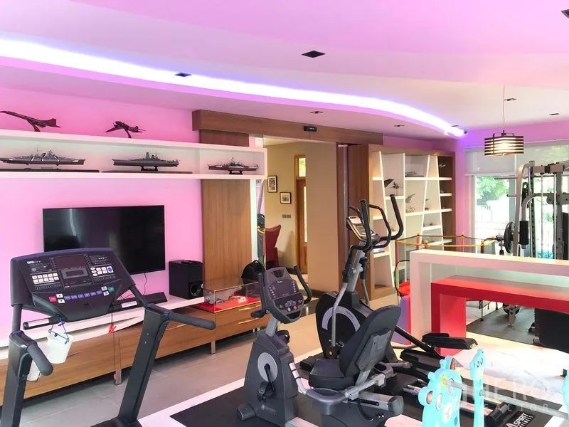Detached House for sale in Wang Thonglang, Bangkok - Home gym room fitted with cardio machines, shelving and LED cove lighting.