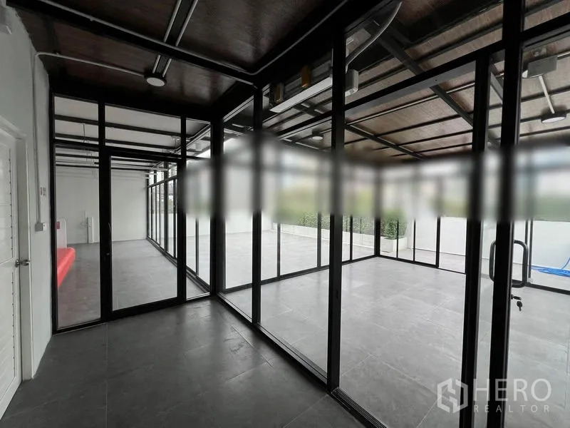 Retail Space for rent in Watthana, Bangkok - Linked glass-partition rooms facing an outdoor terrace in a modern retail space.