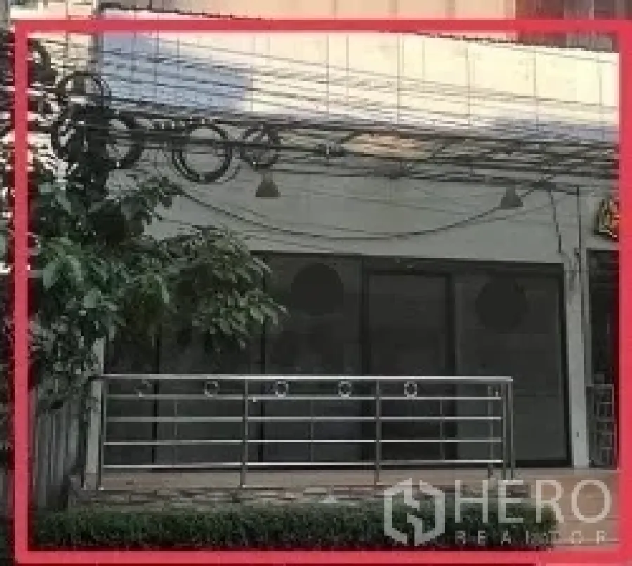 Retail Space for rent - Street-level retail unit with wide glass frontage, metal railing terrace, and signage area near BTS Nana.