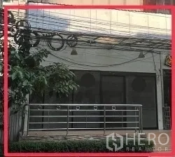 Retail Space for rent - Street-level retail unit with wide glass frontage, metal railing terrace, and signage area near BTS Nana.