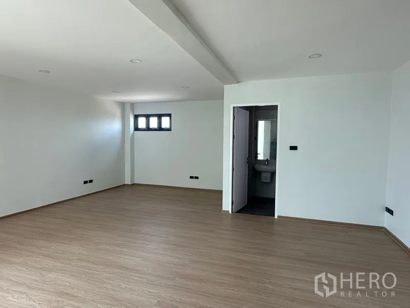 Warehouse for sale in Lam Luk Ka, Pathum Thani - Upper office room with en-suite restroom door and wood-look floor.