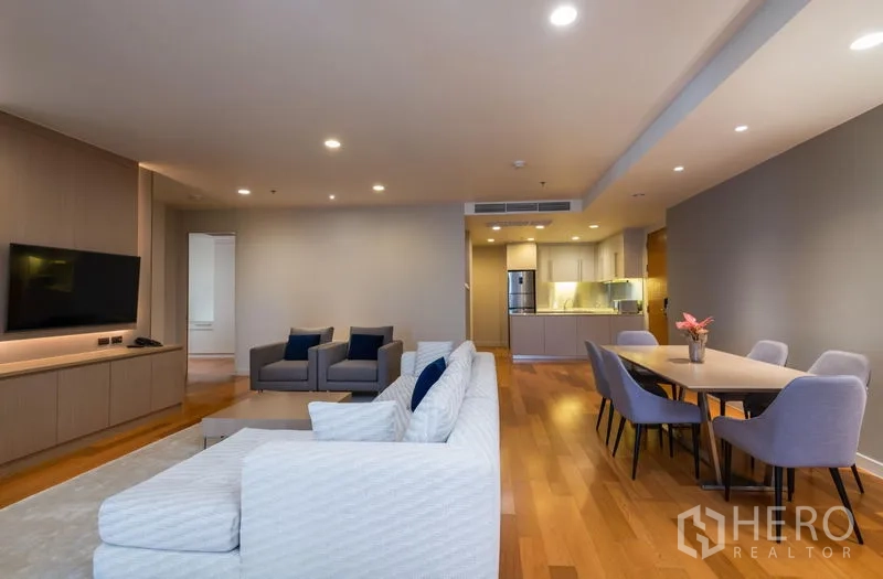 Condominium for rent in Bang Kho Laem, Bangkok - Open‑plan lounge, dining and kitchen zone with recessed lighting and hardwood floors.
