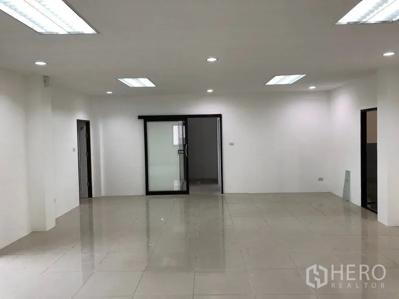 工厂 出租或出售在Samut Prakan - 一层办公室大堂，瓷砖地面与推拉玻璃门。