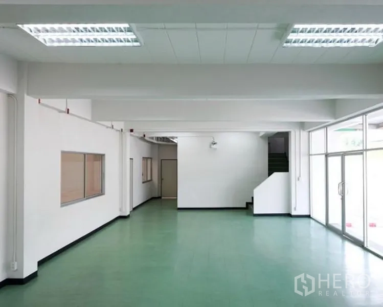 Factory for rent in Pluak Daeng, Rayong - Ground-floor office or showroom area with glass doors and internal staircase to upper level.