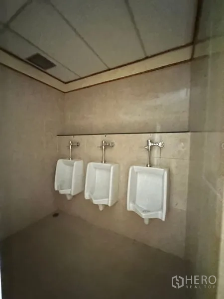 Office Space for rent in Pathum Wan, Bangkok - Men’s restroom with three wall-mounted urinals and tiled walls.