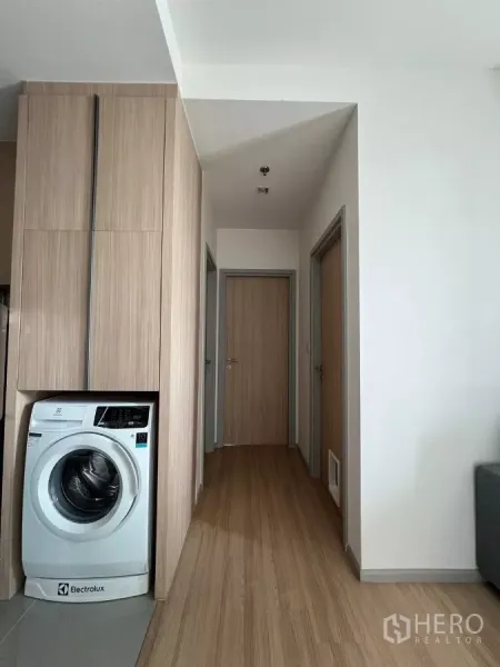 Condominium for rent or sale in Chatuchak, Bangkok - Hallway with tall built‑in storage and a niche for a front‑loading washing machine.