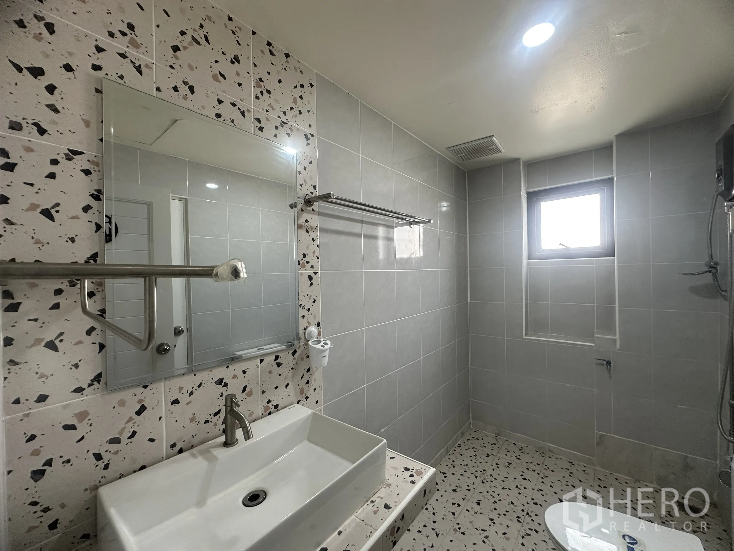 Townhouse for sale in Lam Luk Ka, Pathum Thani - Upper-floor bathroom with terrazzo-style tiles, vanity, and shower.