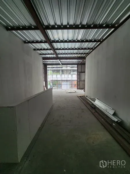 Retail Space for rent in Khlong Toei, Bangkok - Long bare-shell interior with metal roof, white walls, concrete floor, and daylight from full-height glazing.