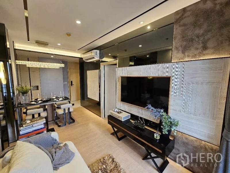 Condominium for rent - Living room media wall with mounted TV, mirrored panels and console.