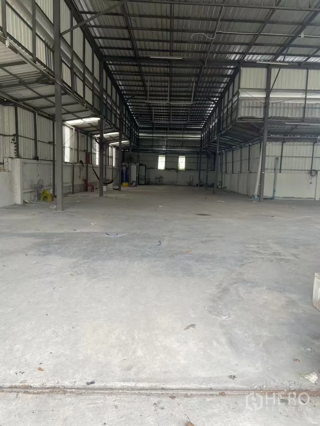 仓库 for rent in Huai Khwang, Bangkok - 仓库纵深视角，可见夹层走道、通风窗与宽阔作业地面。