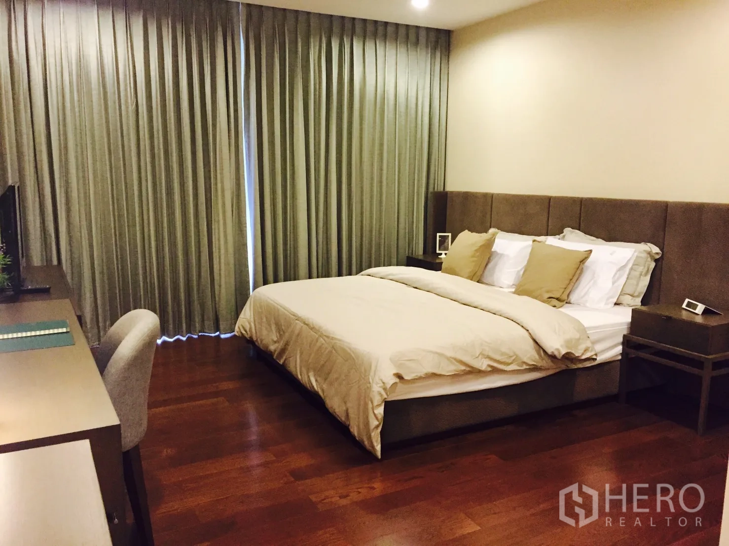 Condominium for rent or sale in Sathon, Bangkok - Spacious master bedroom with a king bed, bedside tables, and floor-to-ceiling curtains.
