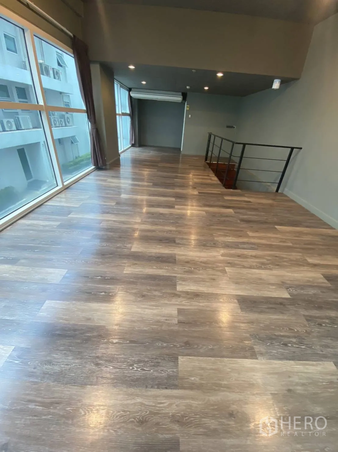 Retail Space for rent in Huai Khwang, Bangkok - Sunlit upper hall with long wood floors, large windows and air conditioner.
