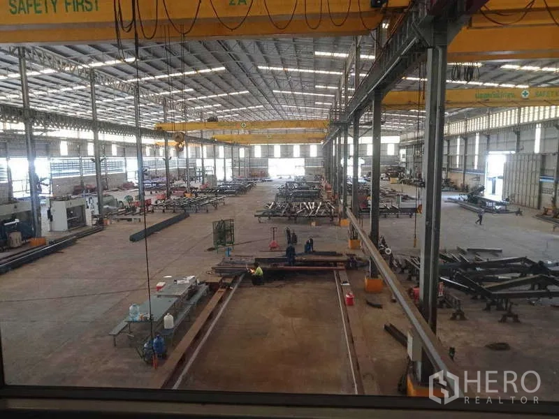 Factory for sale in Chachoengsao - Expansive factory interior with multiple overhead bridge cranes and long fabrication bays.
