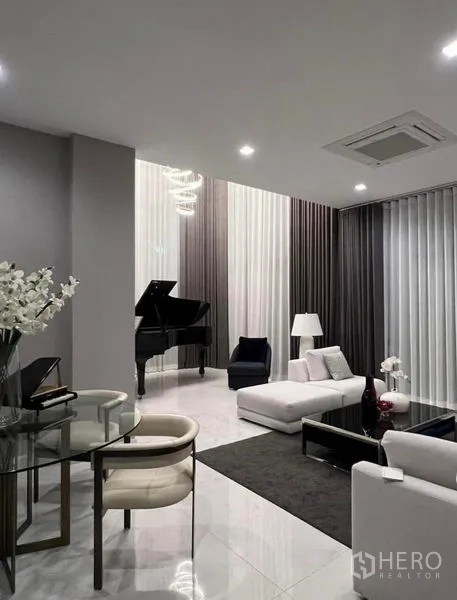 Detached House for rent - Elegant living space with glossy floors, white sectional sofa, chandelier and grand piano.