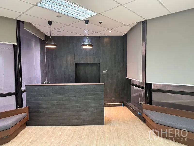 Office Space for rent in Din Daeng, Bangkok - Close-up of reception desk with pendant lights and dark wall panels.