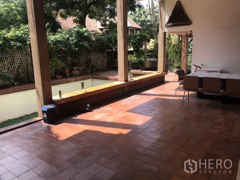 Home Office for rent in Khlong Toei, Bangkok - Shaded patio with terracotta tiles, columns and a long water feature beside the garden.