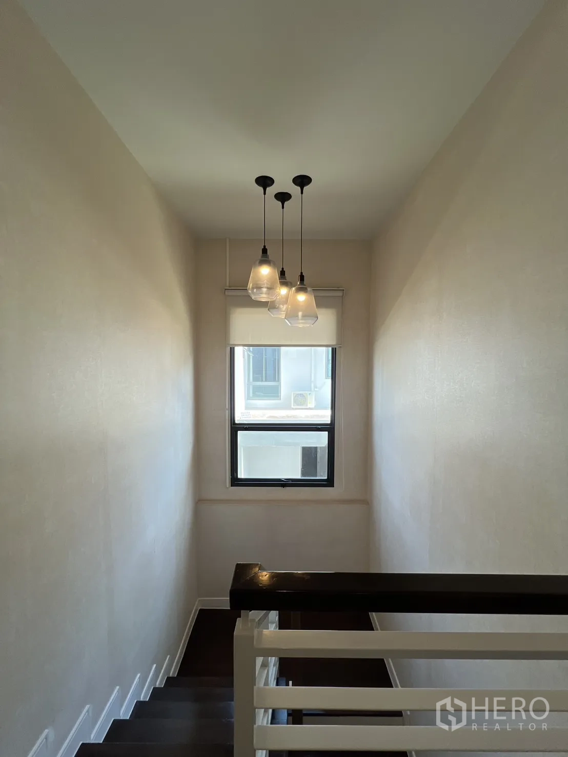Detached House for sale in Bang Kapi, Bangkok - Staircase with pendant lights and natural light from a window.